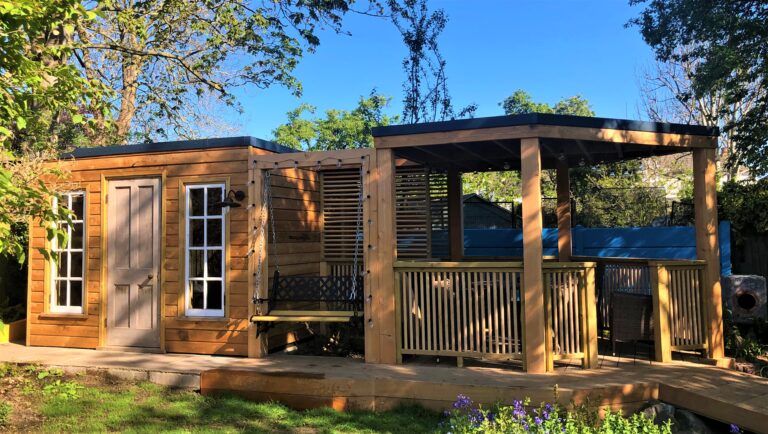 A bespoke outdoor office space with an attached undercover entertaining area made and a bridge over a newly refurbished water feature