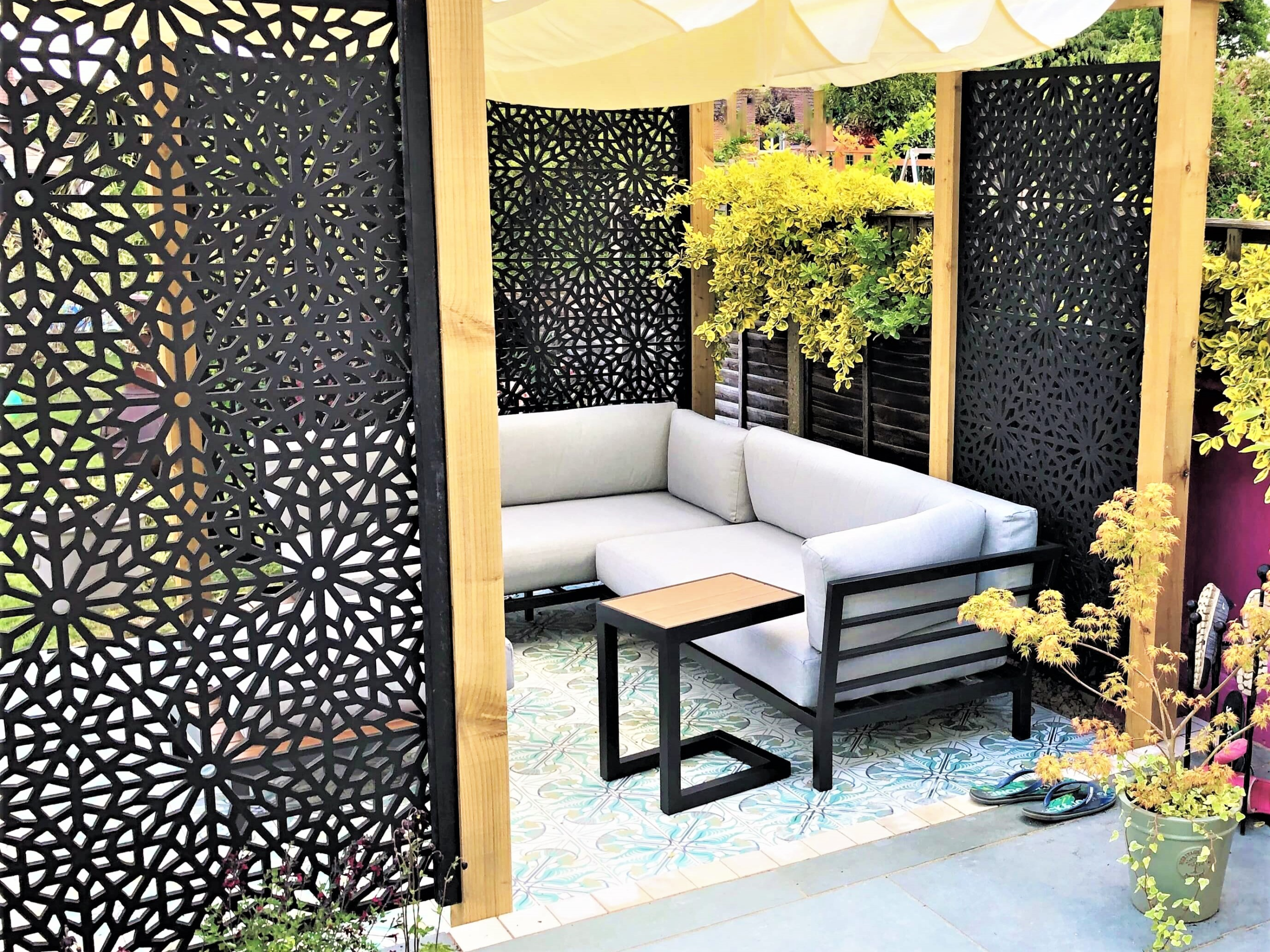 Sunken pergola seating area in a Bexley garden Garden design in Bexley, Kent - sunken pergola seating area with Moucharabiya screens and Jungle Bliss encaustic tiles