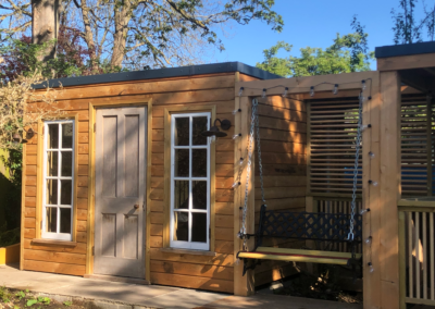 A bespoke garden office building with attached swing seat