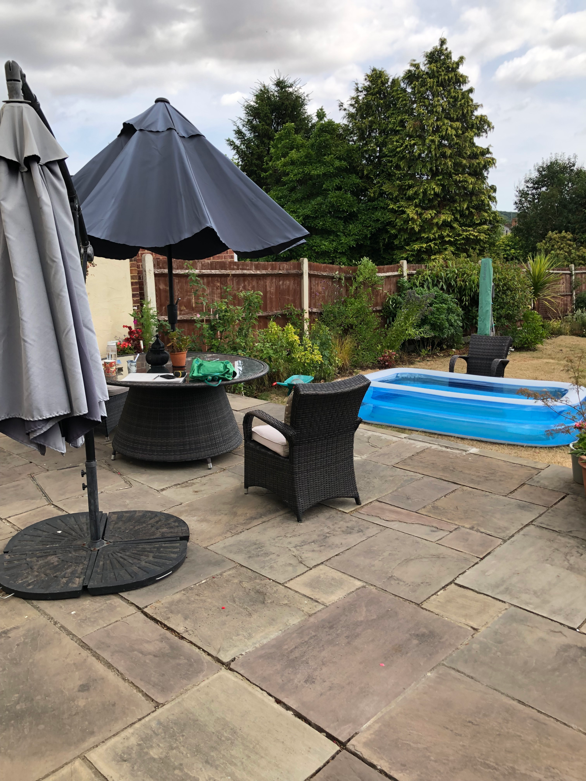 A patio with furniture and a paddling pool
