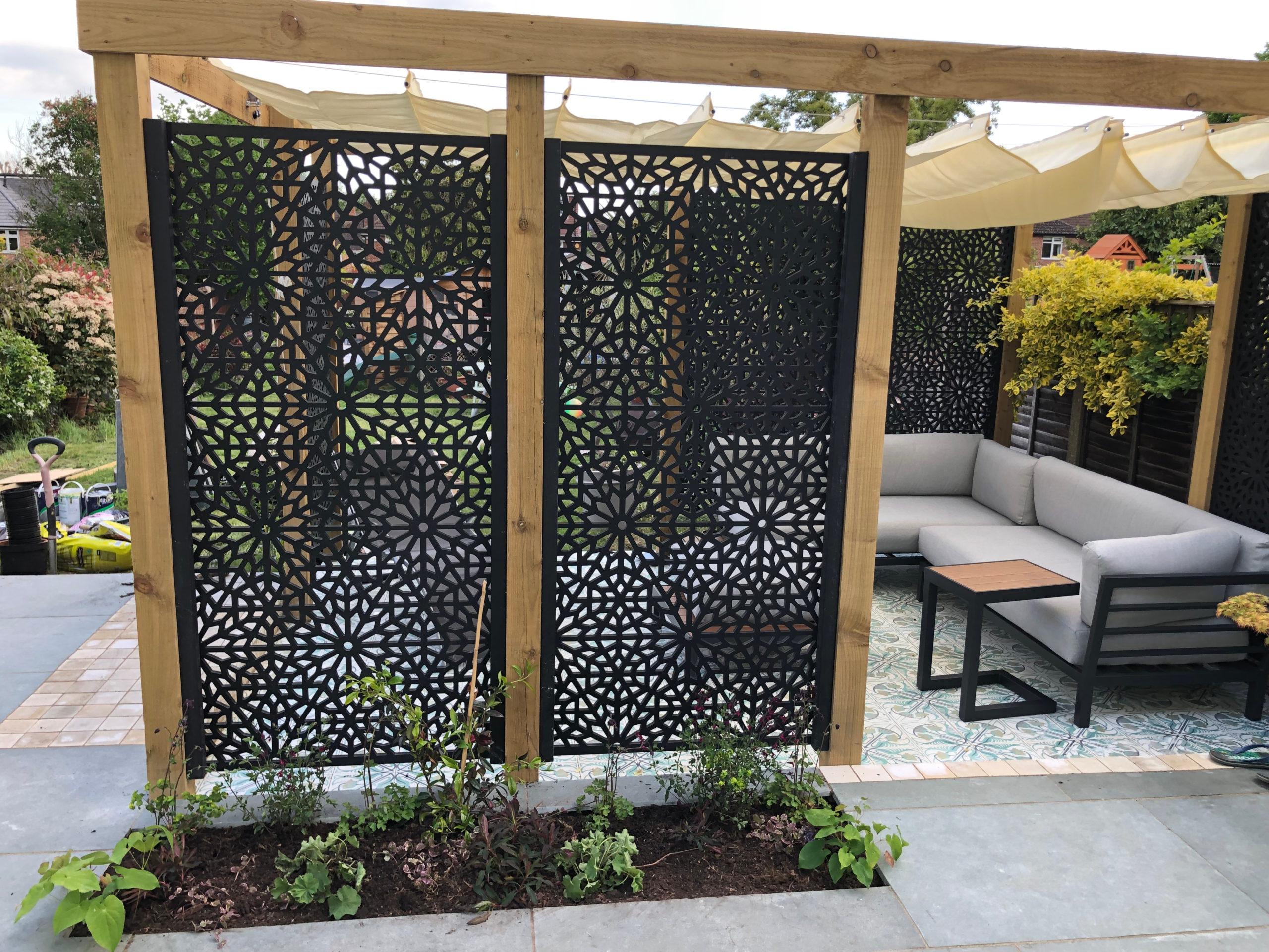 A pergola, a family seating area and some decorative screens