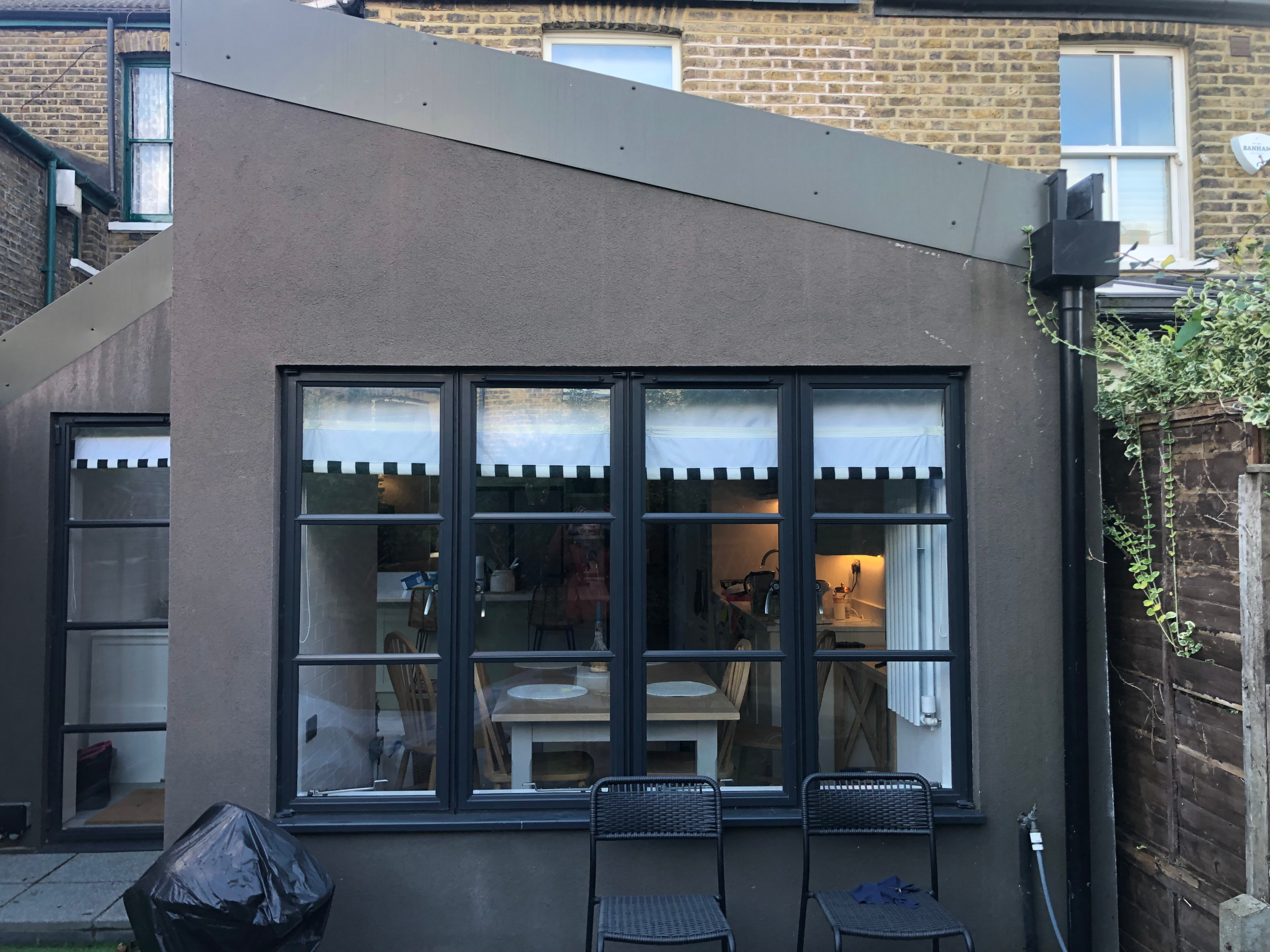 Before the transformation - the brown extension Before - brown rendered extension at a Camberwell home prior to the garden redesign and repaint