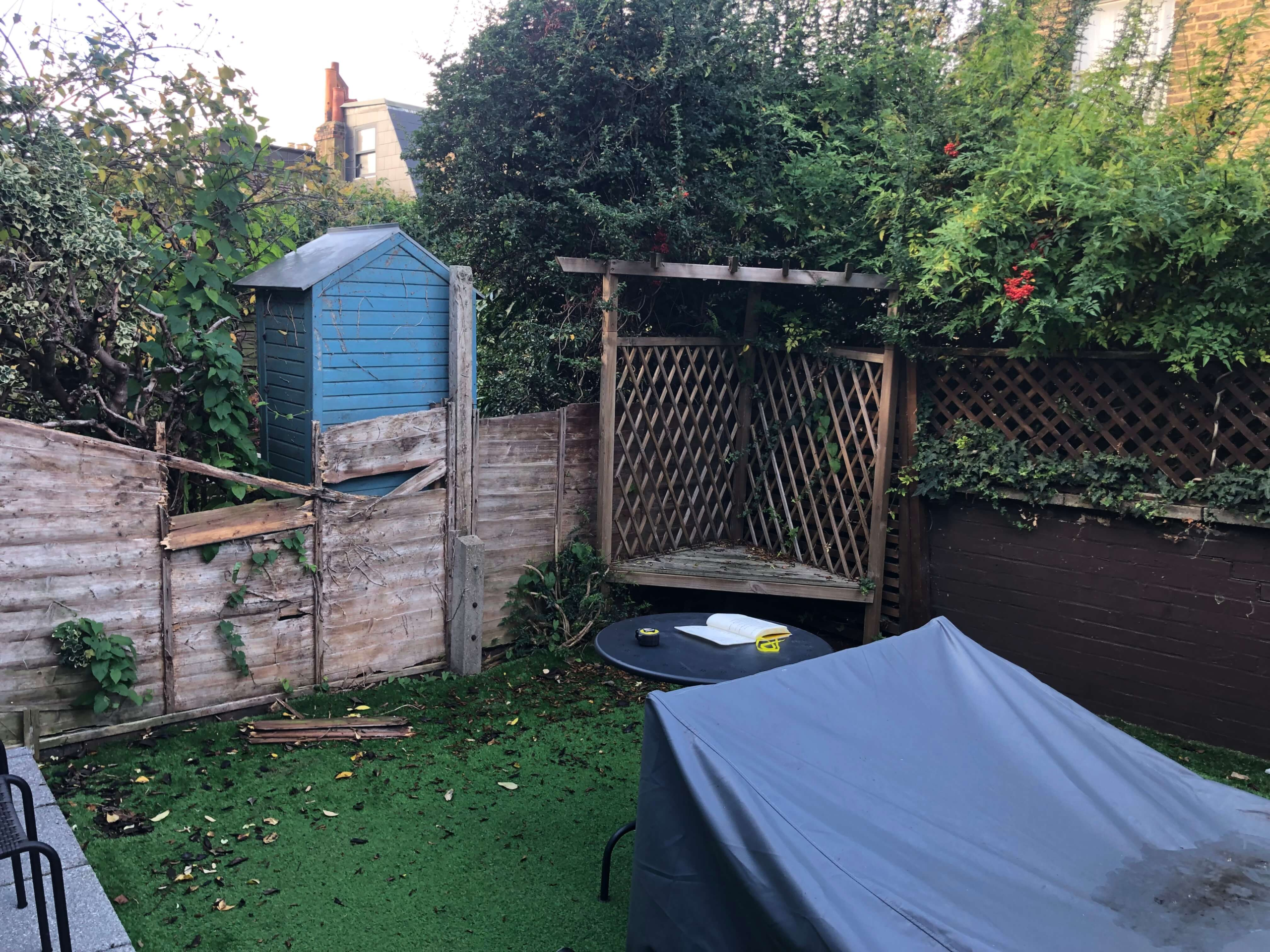Before the transformation - Camberwell garden Alt text:<br />
Before - tired Camberwell garden with broken fencing artificial grass and overgrown boundary prior to redesign